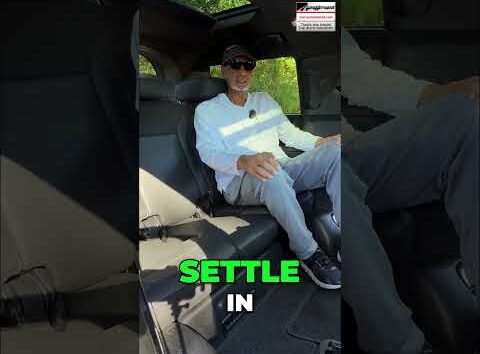 Person adjusting car seat settings for ergonomic comfort in a modern vehicle interior.