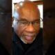 Black activists speaking at a community organizing event focused on grassroots leadership and social justice.