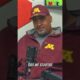 Gopher Sports podcast hosts recording in a studio with Minnesota Golden Gophers team gear and branding in the background.