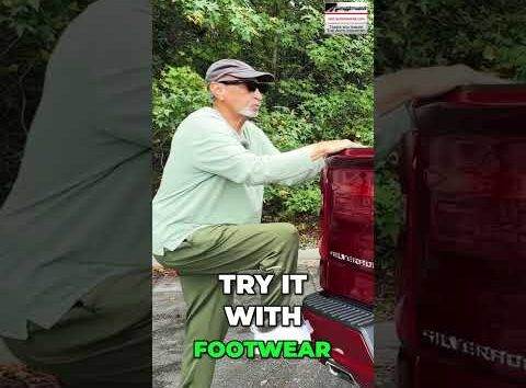 Person standing on a retractable truck bed step to easily reach items in the cargo area of a pickup truck.