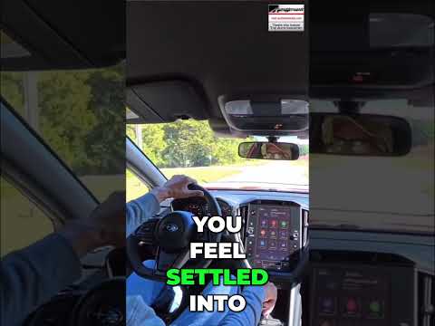 Subaru WRX driver adjusting the seat headrest for comfort and ergonomics in an AutoNetwork car review video.