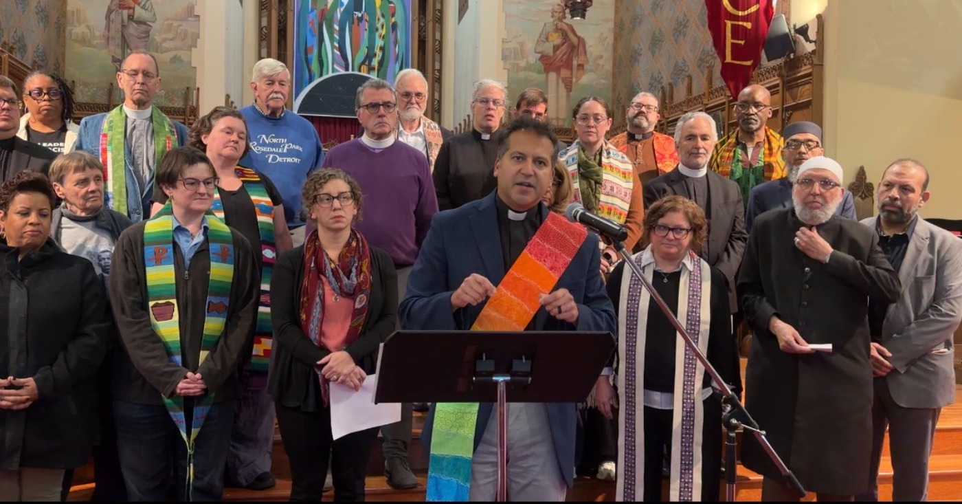 Metro Detroit faith leaders stand behind Rev. Paul Perez of the United Methodist Church downtown Detroit. Photo Samuel Robinson