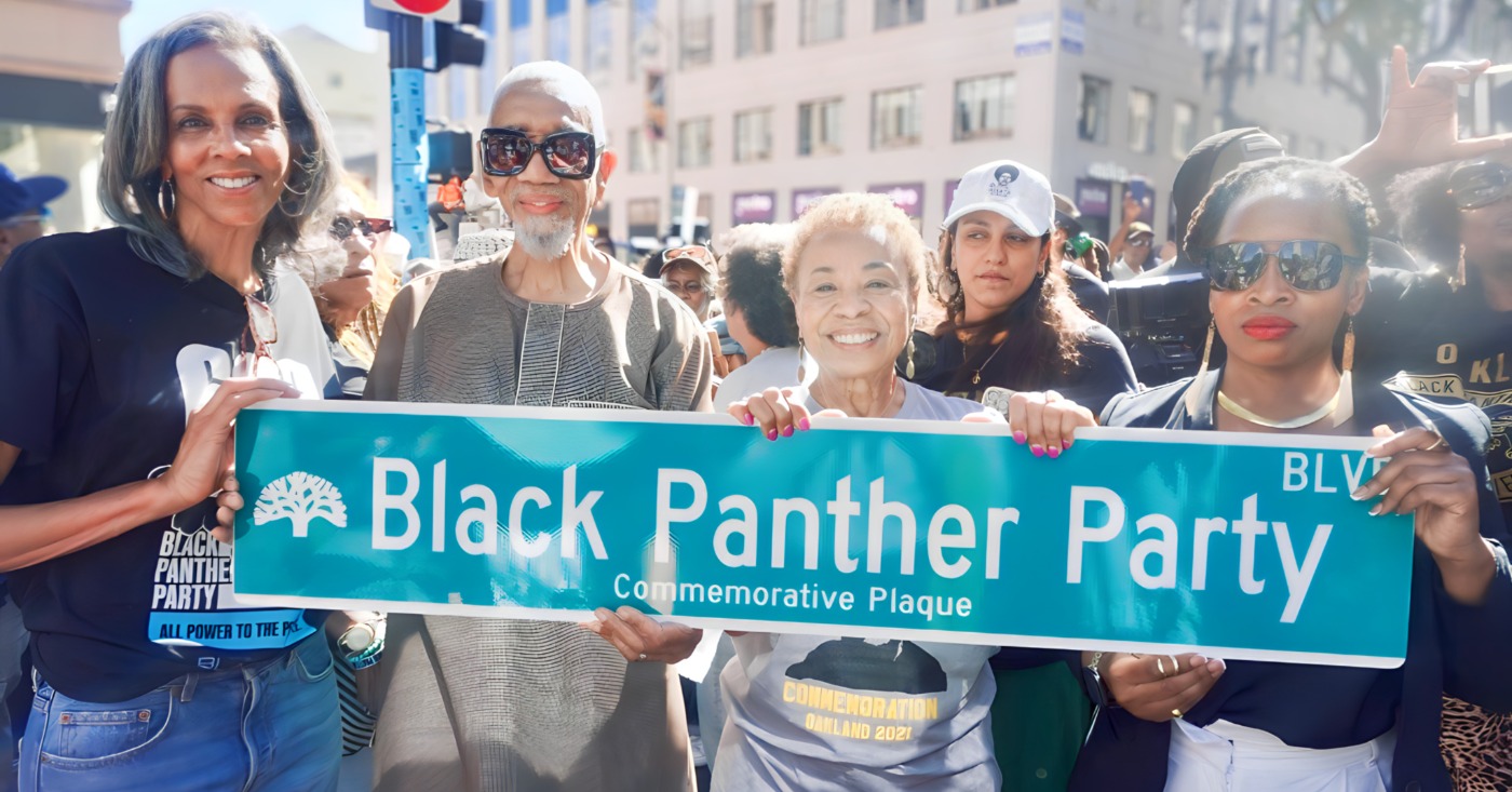 A portion of Broadway from 14th to 17th street was renamed Black Panther Party Boulevard as part of the 60th anniversary of the party’s founding, which was Oct. 15, 1966. Present were (from left) Fredrika Newton, former U.S. Rep. Bobby Rush (the only BPP member elected to Congress); Oakland Mayor Barbara Lee, and District 3 City Councilmember Carroll Fife. Newton, widow of BPP co-founder Huey P. Newton, co-founded the foundation that bears his name as well as the Black Panther Party Museum that is now on BPP Boulevard. Earlier this year, a street was named for BPP co-founder Bobby Seale at 57th and Martin Luther King Jr. Way. Courtesy photo.