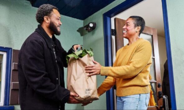 A client receives groceries from a member of Urban Tilth. Courtesy photo.
