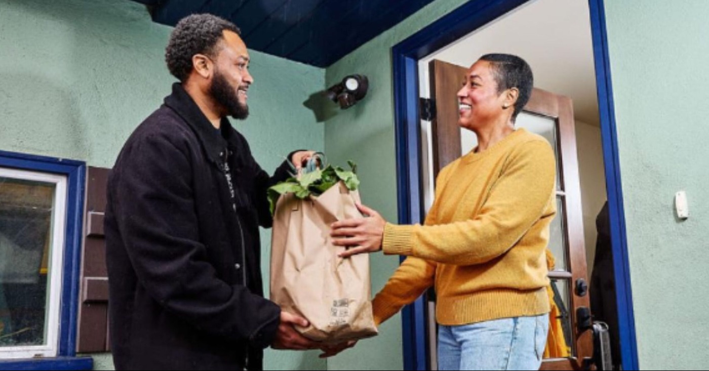 A client receives groceries from a member of Urban Tilth. Courtesy photo.