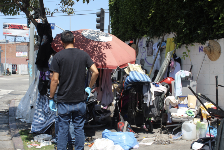St. John’s street medicine staff invite unsheltered residents to receive medical checkups during sidewalk outreach in Los Angeles. Photo by Marion Apio
